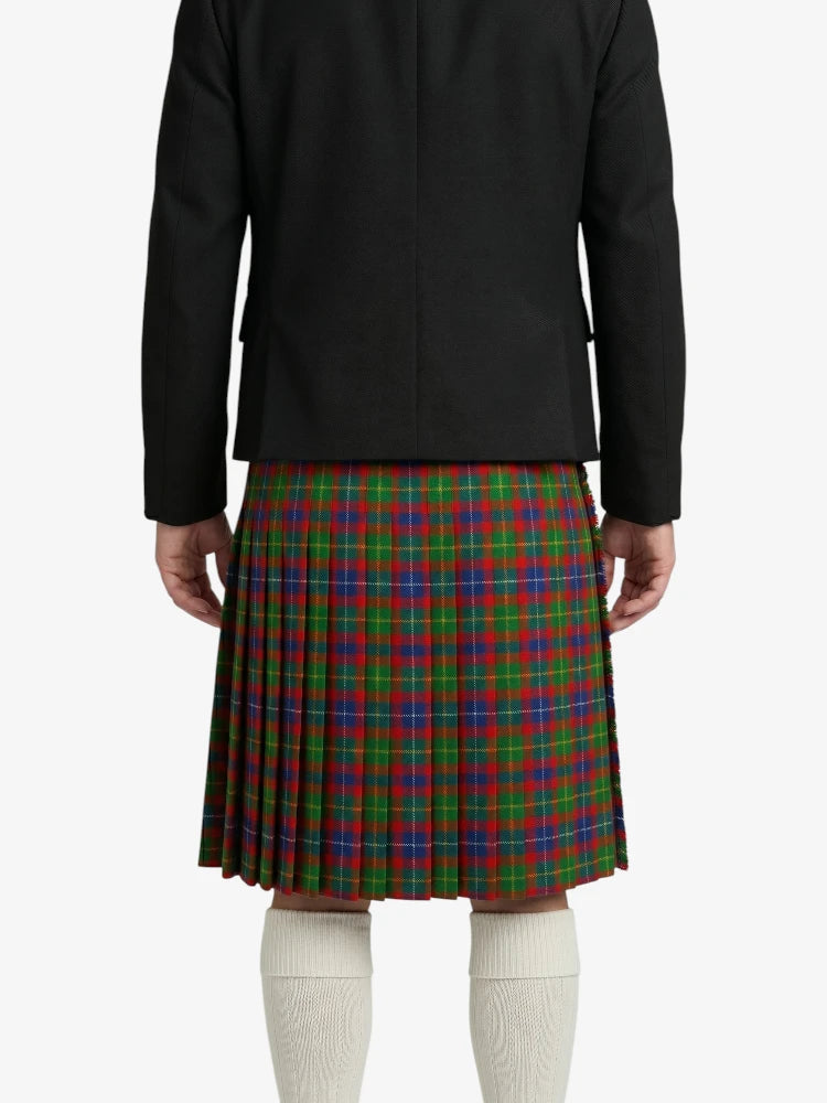 Person wearing a black jacket and red, green, and blue plaid kilt on a white background