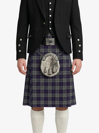 Person wearing a traditional Scottish kilt with a jacket and white knee-high socks on a white background