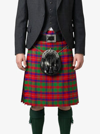 Person wearing a red and green plaid kilt with a black sporran on a white background