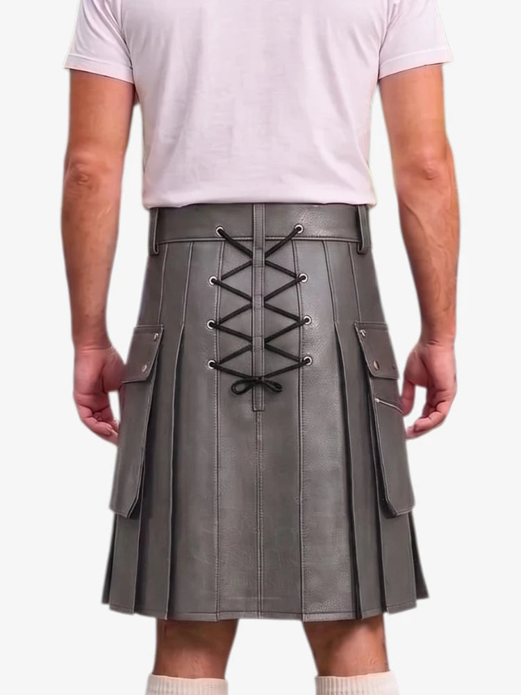 A person shown from the back wearing a gray pleated kilt with black lace-up detailing down the center and side flap pockets, paired with a light pink t-shirt and white socks against a plain white background.