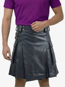 Person wearing a black leather kilt and purple shirt on a white background