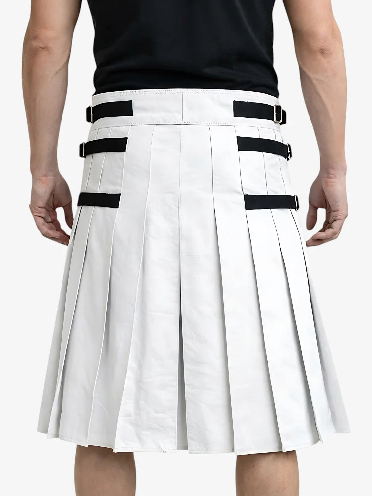 White pleated skirt with black straps worn by a person on a white background