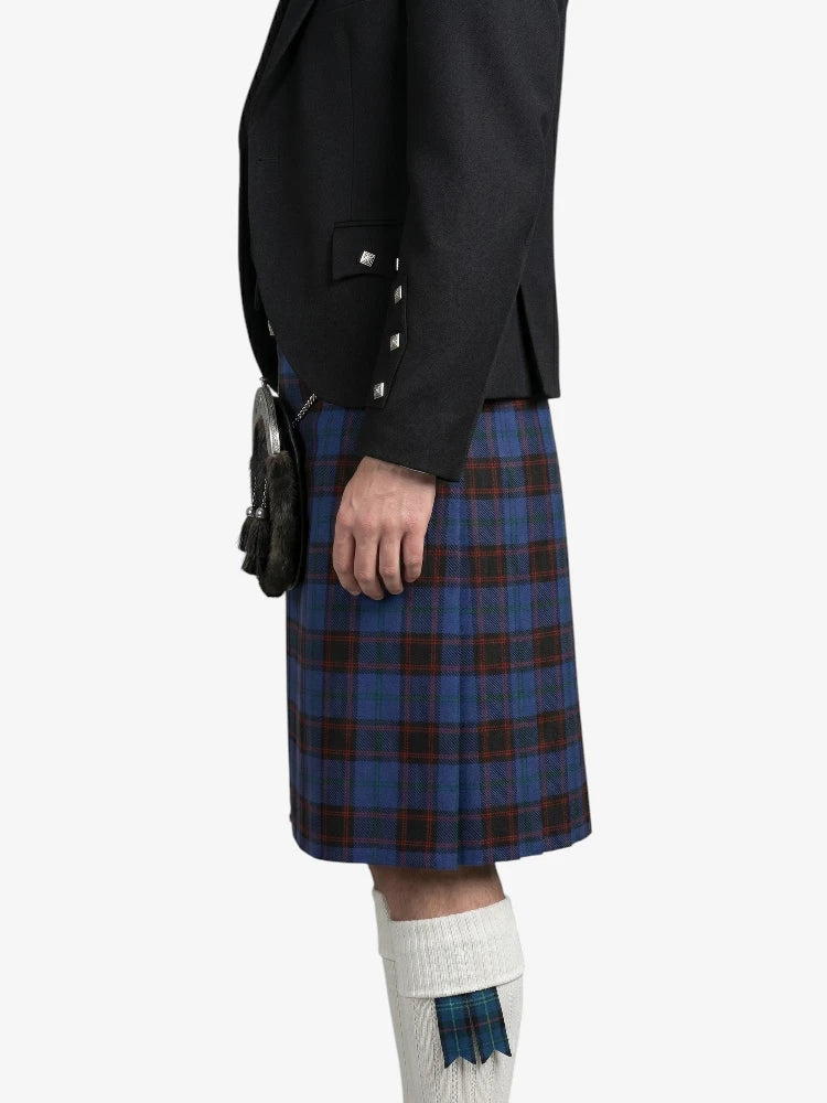 Person wearing a black jacket and blue plaid kilt on a white background