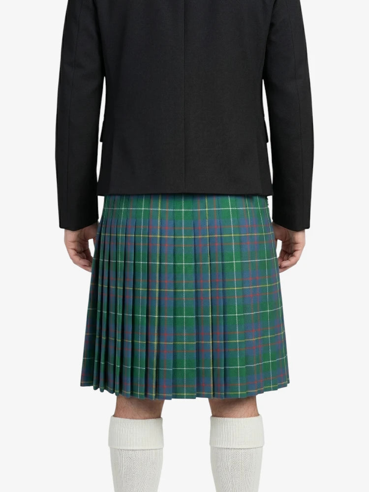 Person wearing a black jacket and green plaid kilt on a white background