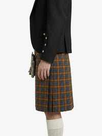 Person wearing a black jacket and plaid kilt on a white background