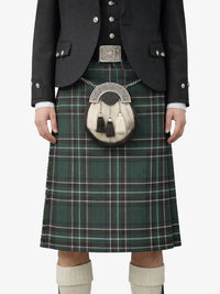 Person wearing a traditional Scottish kilt with a sporran on a white background