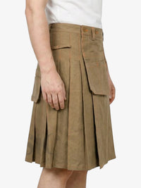 Brown pleated skirt worn by a person on a white background