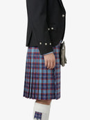 Person wearing a black jacket and blue plaid kilt on a white background