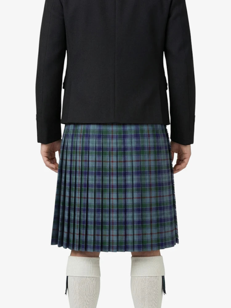 Person wearing a black jacket and plaid kilt on a white background
