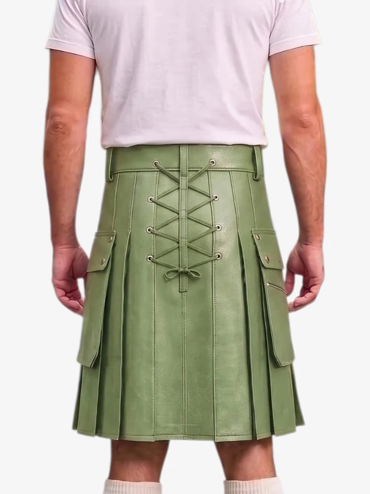 A person shown from the back wearing a sage green pleated leather kilt with a central lace-up closure and side cargo pockets, paired with a light pink t-shirt and white socks.