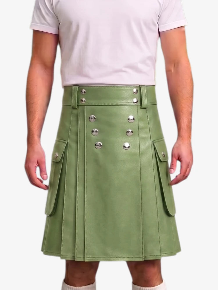 A person wearing a sage green faux-leather kilt with silver-tone decorative buttons and side flap pockets, paired with a light pink t-shirt against a plain white background.