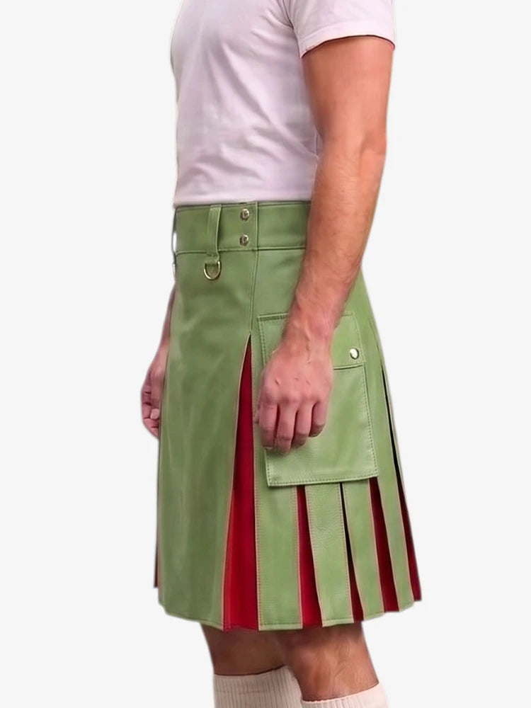 A man wearing a light green faux-leather kilt with red pleated inserts and brass hardware, paired with a white t-shirt and white socks, shown from the waist down against a light gray background.