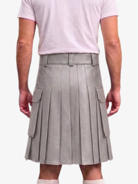 A person shown from the back wearing a light gray pleated mini skirt with side flap pockets and a matching belt, paired with a pale pink T-shirt against a light gray studio background.