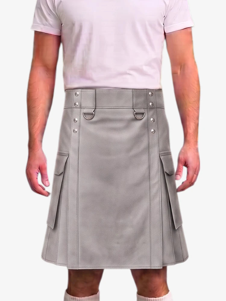 A man wearing a light gray faux-leather kilt with silver-tone hardware, side cargo pockets, and a matching gray belt, paired with a light pink t-shirt.