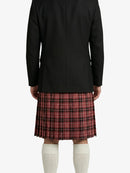 Person wearing a black jacket and red plaid kilt on a white background