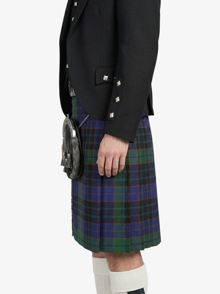 Person wearing a black jacket and plaid kilt on a white background