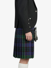 Person wearing a black jacket and green plaid kilt on a white background