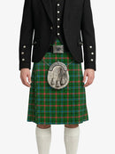 Person wearing a green plaid kilt with a black jacket on a white background