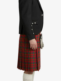 Person wearing a black jacket and red plaid kilt on a white background