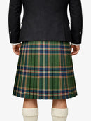Person wearing a dark jacket and green plaid kilt on a white background