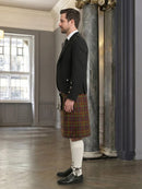 Man wearing a traditional Scottish kilt in an elegant interior setting