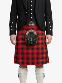 Person wearing a red tartan kilt with a black jacket on a white background