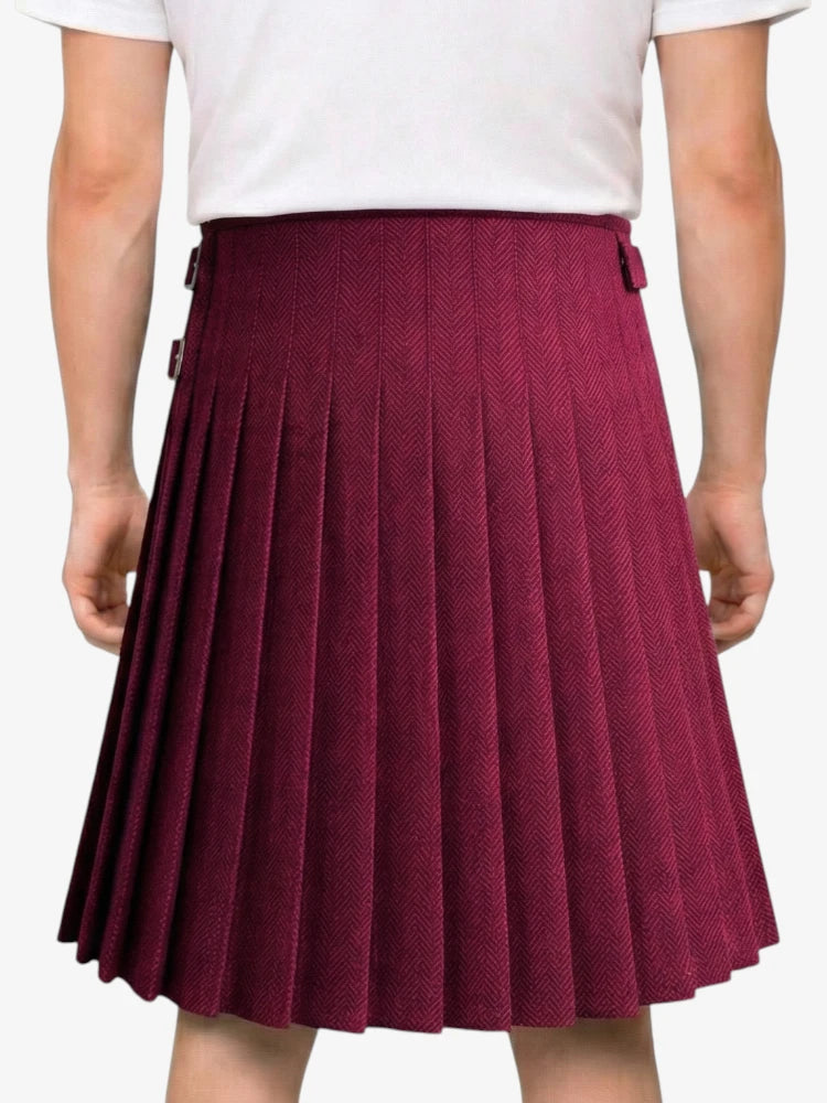 Maroon pleated skirt worn by a person on a white background