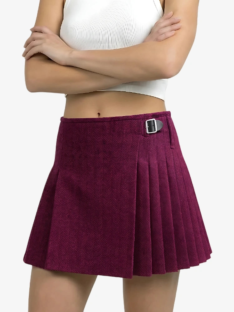 Purple pleated skirt worn by a person on a white background