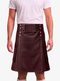 A person wearing a dark brown faux-leather kilt with silver-tone metal hardware, a belt with silver rivets, and side cargo pockets, paired with a light pink t-shirt.