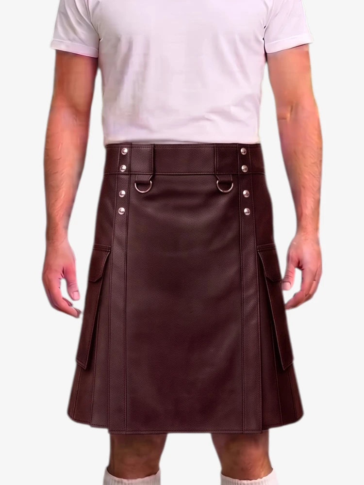 A person wearing a dark brown faux-leather kilt with silver-tone metal hardware, a belt with silver rivets, and side cargo pockets, paired with a light pink t-shirt.
