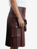 Maroon pleated kilt worn by a person on a white background