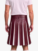 A person shown from the back wearing a pleated leather kilt with vertical burgundy and white stripes, paired with a light pink t-shirt and white socks, against a plain light gray background.