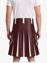 A man wearing a pleated faux-leather kilt in burgundy with white vertical stripe panels and white belt loops, paired with a white t-shirt, shown from the back against a light gray background.