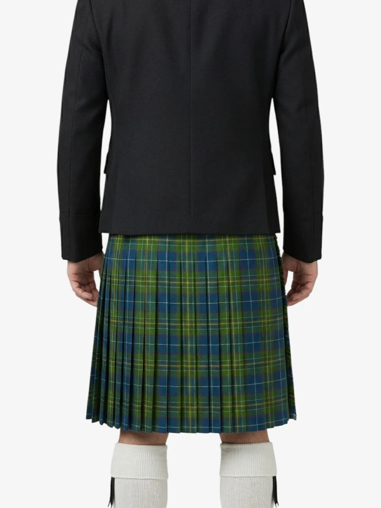 Person wearing a black jacket and green plaid kilt on a white background