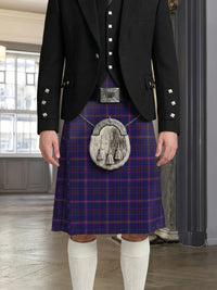 Person wearing a traditional Scottish kilt with a visible tartan pattern and a jacket.