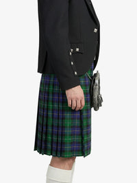 Person wearing a black jacket and green plaid kilt on a white background