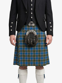 Person wearing a traditional Scottish kilt with a patterned sash on a white background