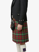 Person wearing a black jacket and red plaid kilt on a white background