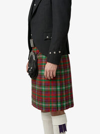 Person wearing a black jacket and red plaid kilt on a white background