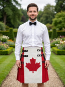 A man standing in a formal garden wearing a white shirt, black bow tie, and a red and white kilt with a large red maple leaf design on the front.