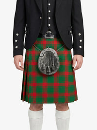Person wearing a black jacket and red and green plaid kilt on a white background
