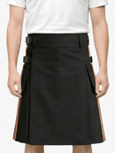 Black skirt with orange accents worn by a person on a white background