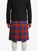 Person wearing a black blazer and red plaid kilt on a white background