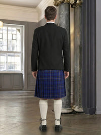 Person wearing a dark jacket and blue plaid kilt in an elegant interior setting.