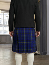 Person wearing a black jacket and blue plaid skirt indoors.