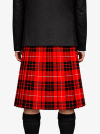 Person wearing a red plaid kilt on a white background