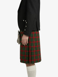 Person wearing a black jacket and red plaid kilt on a white background