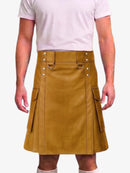 A mustard yellow faux-leather kilt with silver-tone metal hardware, worn by a model in a light pink t-shirt against a plain white background.