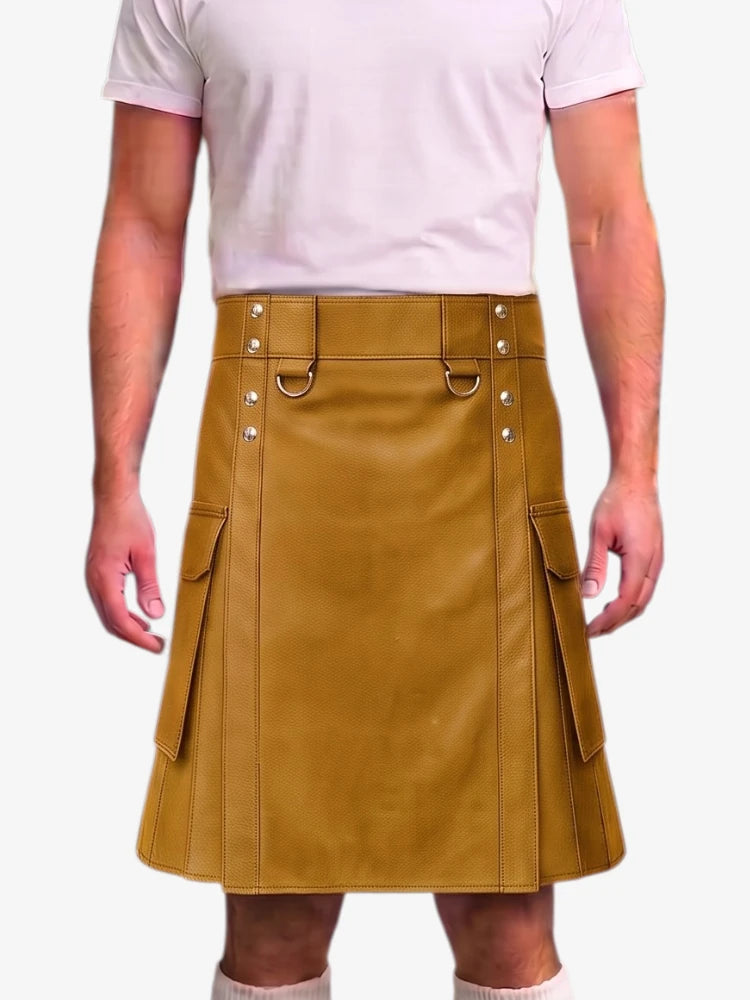 A mustard yellow faux-leather kilt with silver-tone metal hardware, worn by a model in a light pink t-shirt against a plain white background.