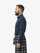 Man wearing a blue shirt and tartan kilt on a white background